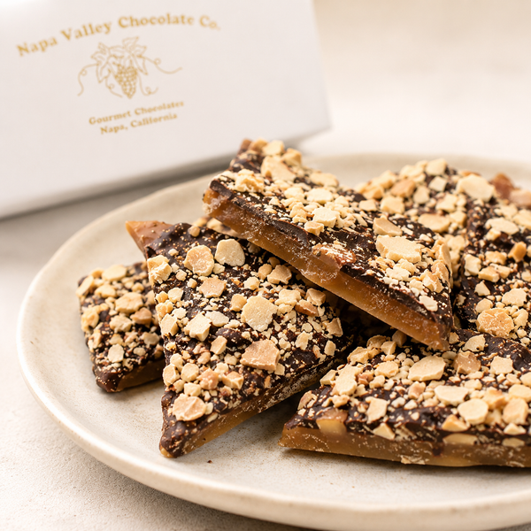 Close-up of crisp English Toffee with chocolate coating and toasted nuts.
