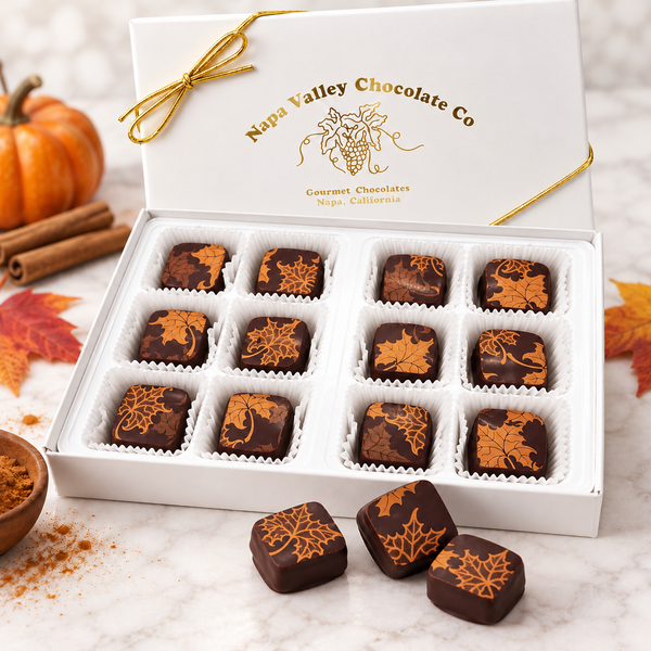 Napa Valley Chocolate Company 12-piece gift box of chocolate covered pumpkin spice caramels with copper autumn leaf designs, white candy cups, and gold ribbon.